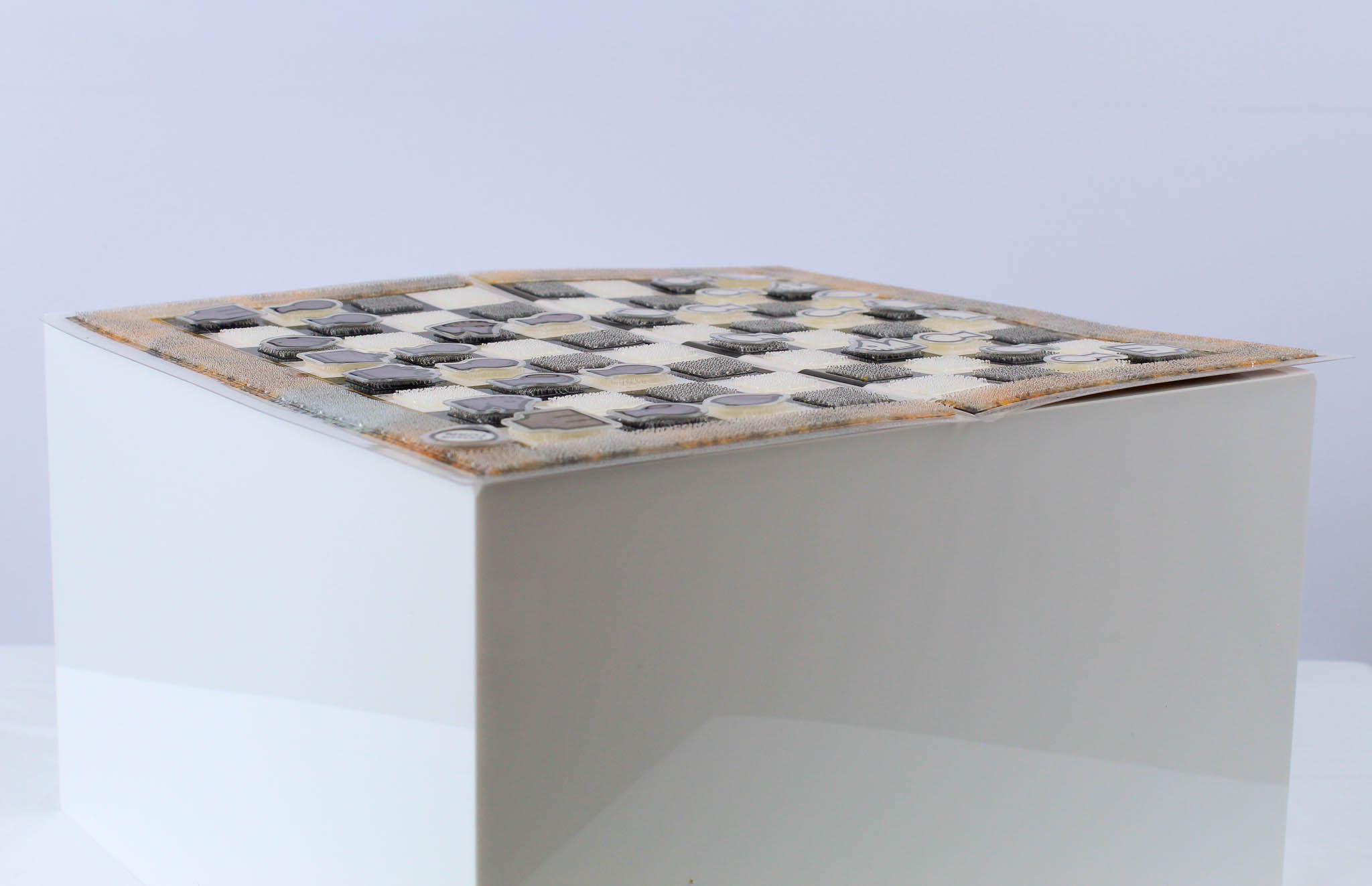 An open Travel Chessboard with Orange Lichen design from the side to highlight the low-profile design on a white background.