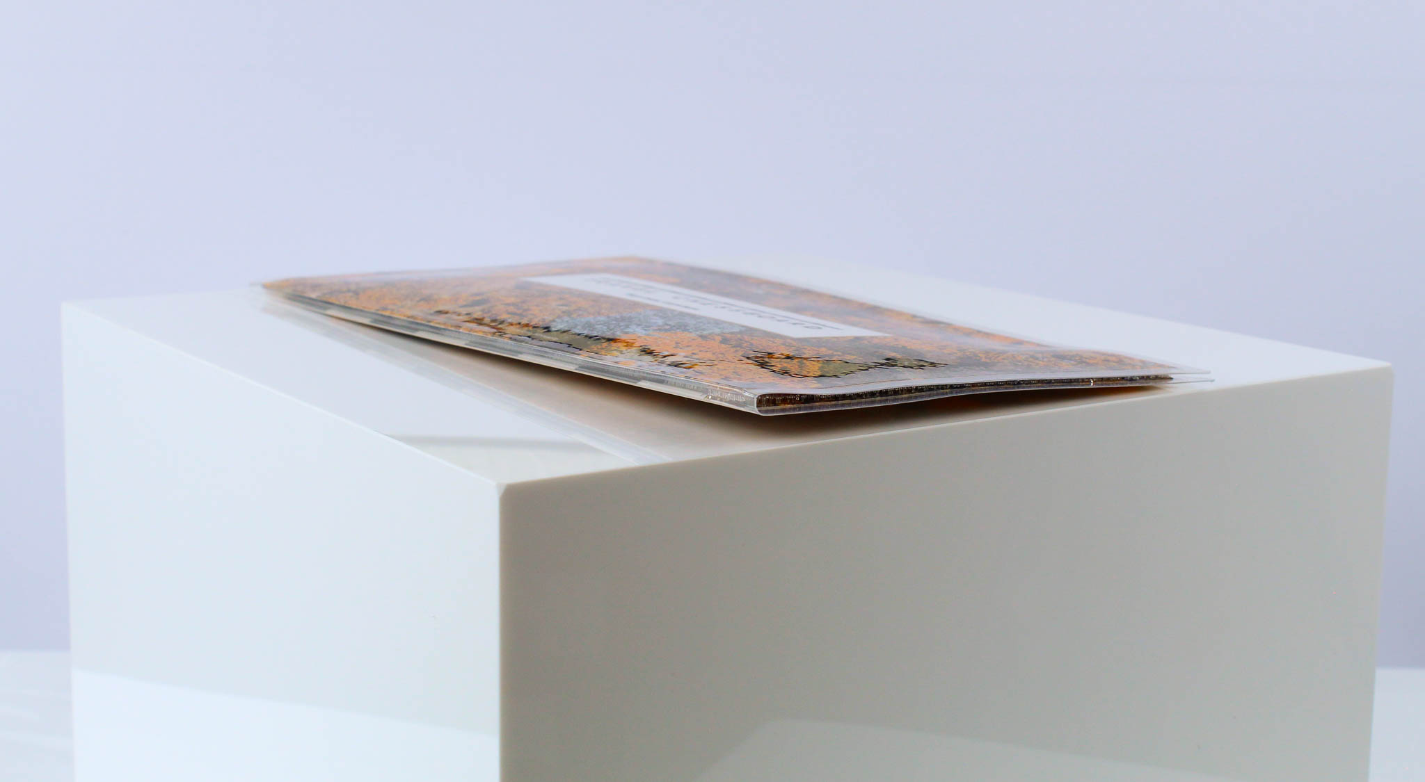 A closed Travel Chessboard with Orange Lichen design from the side to highlight the low-profile design on a white background.