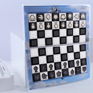 Blue Sky Travel Chessboard open and upright on a white background next to a "how to play" insert laying down flat.